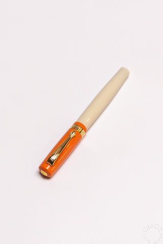 Orange student fountain pen with medium nib, beige grip and gold nib hardware