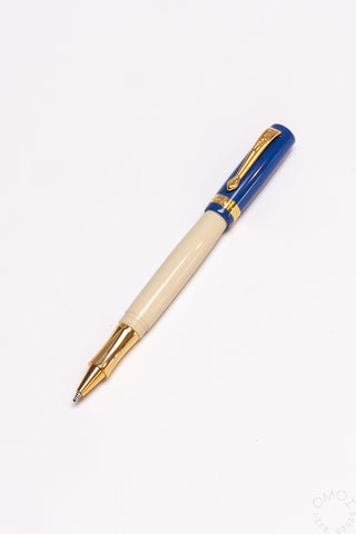 Student rollerball pen with beige barrel and blue cap with gold accents