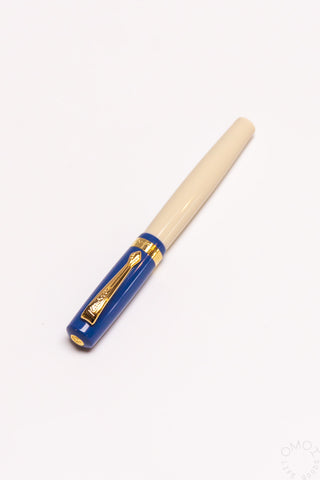 Student rollerball pen with beige barrel and blue barrel band with gold clip