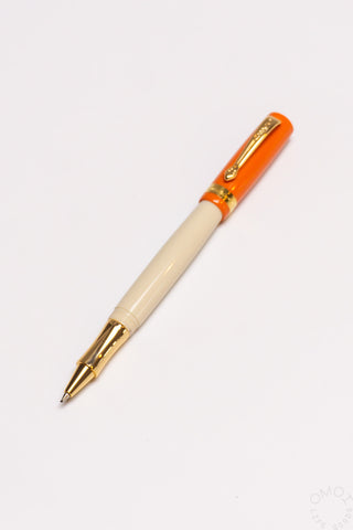 Student rollerball pen with beige barrel and orange cap with gold accents