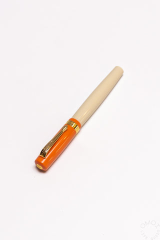 Orange and cream student rollerball pen with gold clip and nib tip