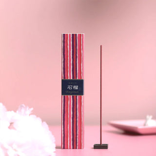 Striped pomegranate incense bundle with upright stick and black base stand