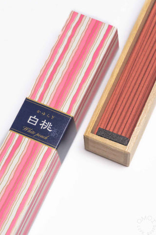 Striped incense sleeve and wooden holder showing dark red/brown incense sticks