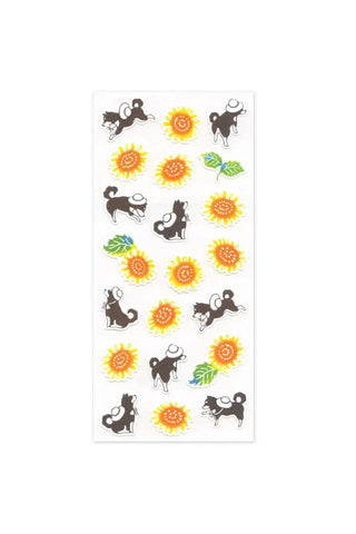 Sticker sheet with black dog icons, orange sunflowers, and green leaves