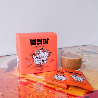 Instant latte mix box with latte in a mug and two orange sachet packs