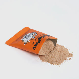 Orange instant latte sachet with light brown powder spilled out