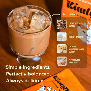 Iced latte in glass mug beside orange instant mix box ingredients highlights