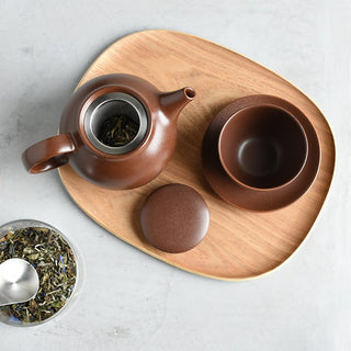 Brown teapot with open lid and infuser insert, spout and round handle on tray