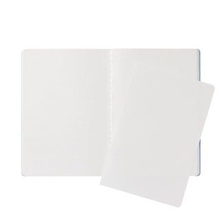 White B6 2mm grid notebook opened, with two textured pages and a stitched center seam