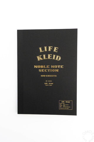 A5 notebook with black cover and gold LIFE KLEID lettering