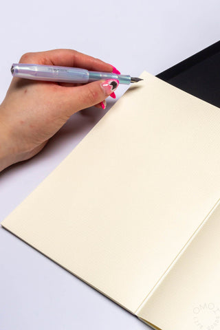 A5 notebook with cream pages and pen writing on the sheet