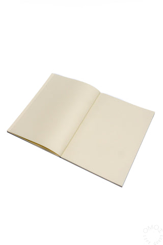 A5 notebook open to light pages with stitched binding