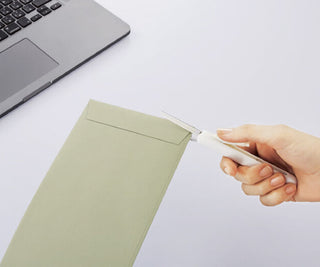 Compact scissors with white handle trimming paper