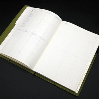Open olive A5 notebook cover with white grid pages and olive borders