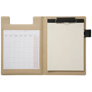 A5 field pad in beige, open view with paper and metal clip, elastic strap