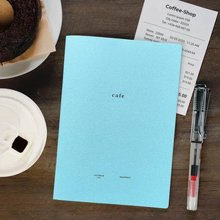 Light blue cafe B6 style notebook on desk with matching cafe cover text