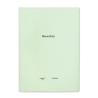 Light green notebook cover titled "Monthly" with small logo marks