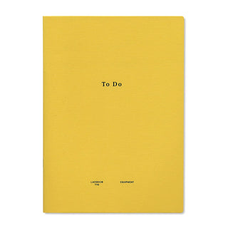 Yellow To Do planner notebook cover with centered title and small brand marks.