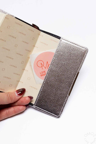Silver textured pocket log diary closed with ribbon inside and interior page visible