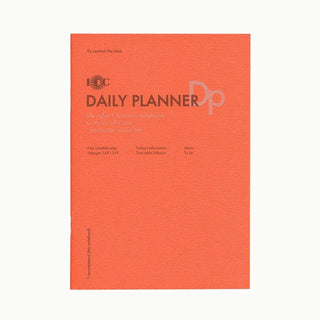 Orange A5 daily planner notebook with DAILY PLANNER title on the cover.