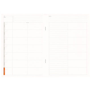 A5 weekly planner notebook open to blank weekly grid pages with orange edge accent