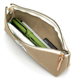 Greige LUDDITE boat pen case opened, showing green pen inside.