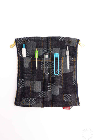 Patchwork plaid pen case pouch with pens inserted and metal eyelets, gold zipper