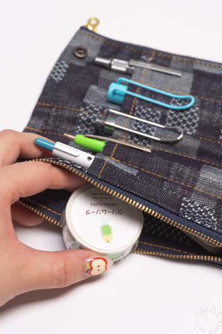 Denim patchwork pen case pouch with multicolor pens and gold zipper edge