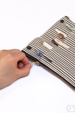 Striped pen case pouch with gold zipper and embroidered pen icons on fabric