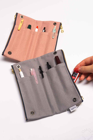 Pink and grey bendy pen case with multiple pen slots and snap buttons