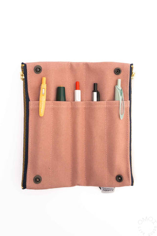 Pink bendy pen case open with pen slots and snap button corners