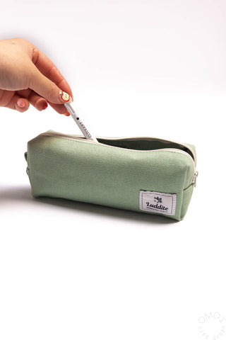 Sage box pen case with zipper opened while a hand pulls out a marker
