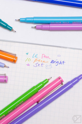 Assorted bright gel pens with colored barrels, tips visible on notebook paper