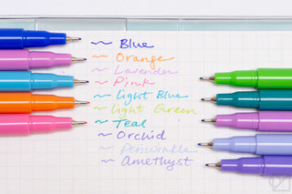 Bright colored gel pens laid out in a row, multiple tip colors visible