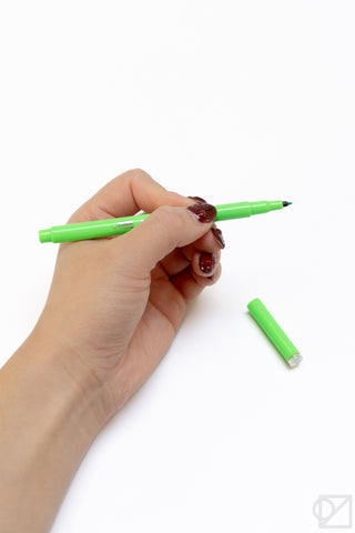 Le Pen Flex gel pen, fluorescent green body held in a hand