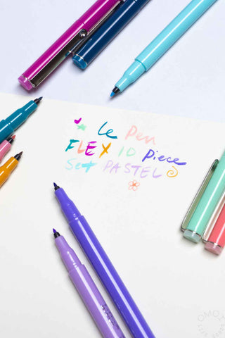 Pastel brush markers set, ten pens with colored tips arranged on flat surface