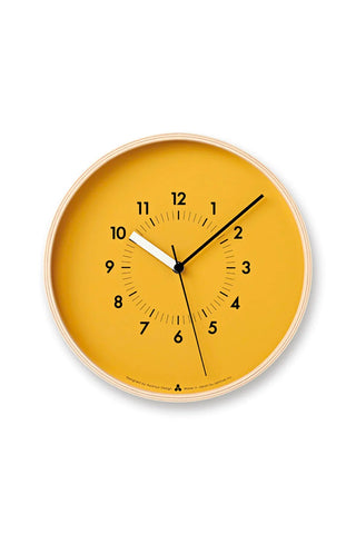 Round wall clock with orange dial, black hands, and light gold outer ring.