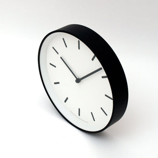 Round wall clock with white dial, black hands, and raised black bezel