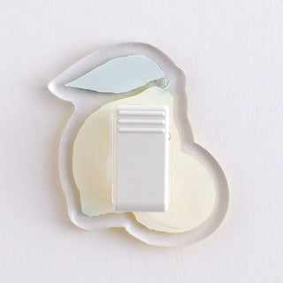 Lemon acrylic clip close-up with white back and ribbed clasp, leaf and lemon front