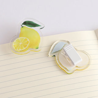 Lemon acrylic clip holding paper, featuring yellow lemon wedge with green leaf detail