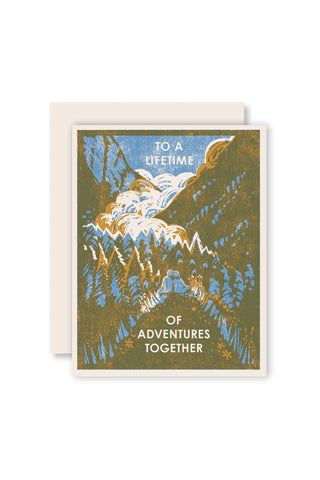 Letterpress greeting card with forest, bird, and text 'To a lifetime of adventures together'