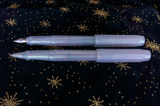 Two iridescent pearl rollerball pens, light-blue translucent barrels