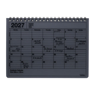 2027 notebook calendar page with dark cover, spiral binding, weekly grid layout