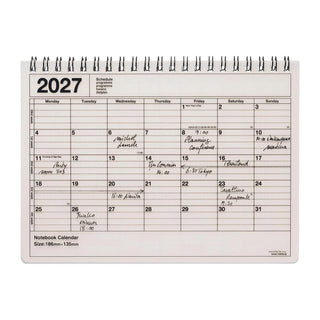2027 notebook calendar page with light cover, spiral binding, monthly calendar grid