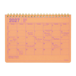 2027 notebook calendar page with orange cover, spiral binding, monthly calendar grid