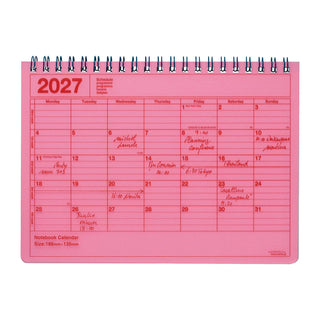 2027 notebook calendar page with pink cover, spiral binding, monthly date layout