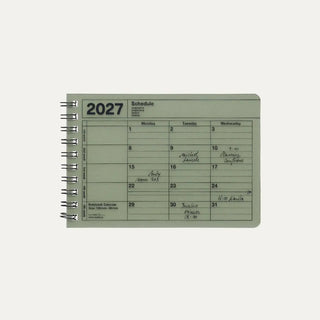 Green 2027 notebook calendar cover showing a weekly schedule page and spiral rings