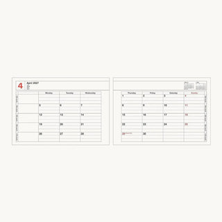 Small 2027 notebook calendar with two open monthly pages side by side and spiral rings