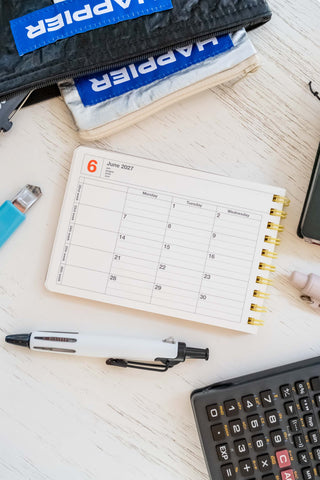Open 2027 schedule planner page with grid layout and spiral binding in a small notebook