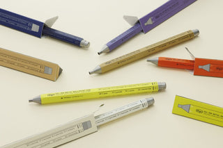 Multi-color gel ink metal pens laid out with two small product boxes